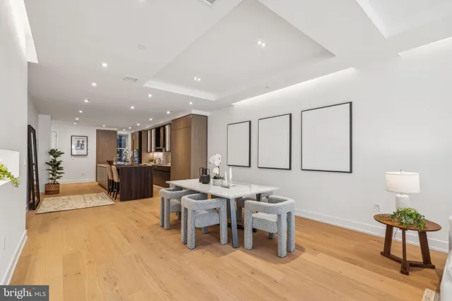 a living room with furniture a wooden floor and next to a window