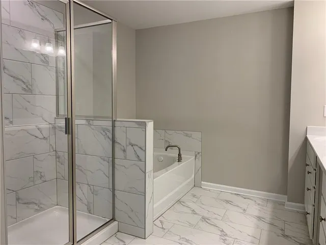 a bathroom with a bathtub and shower