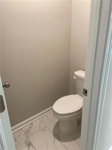 a white toilet sitting next to a sink