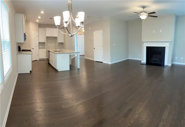 a view of a kitchen with granite countertop stainless steel appliances and wooden floor