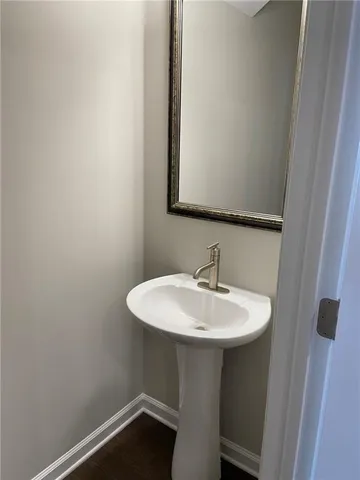a bathroom with a sink a mirror and a toilet
