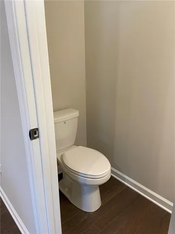 a white toilet sitting next to a shower