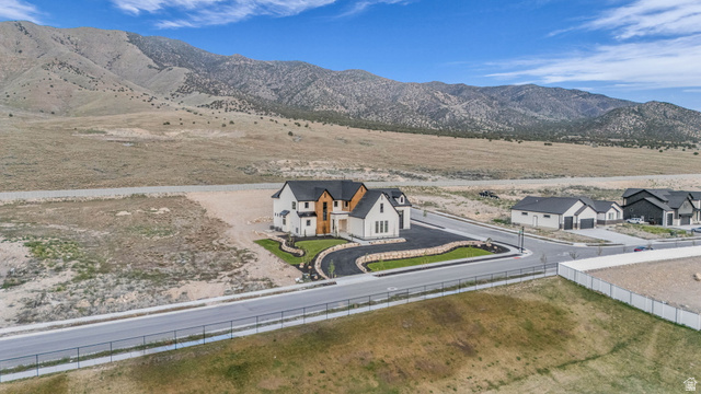 2828 Jojo Road Eagle Mountain, UT 84005 - Photo 59 of 63 Modern farmhouse-style home with a black roof and light-colored siding