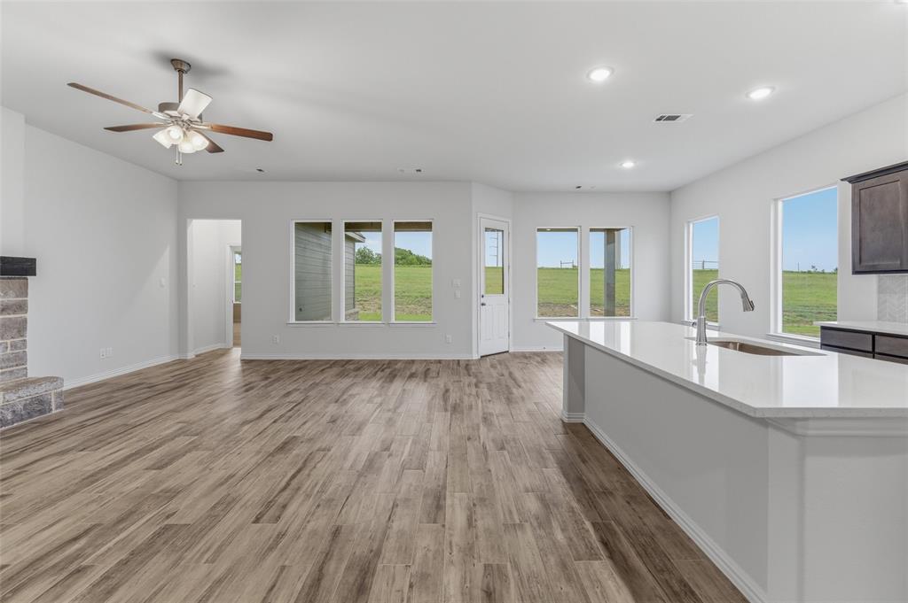119 Hillview Trail Decatur, TX 76234 - Photo 18 of 30 Expansive open-concept living area featuring wood-finish flooring, a ceiling fan, and recessed lighting