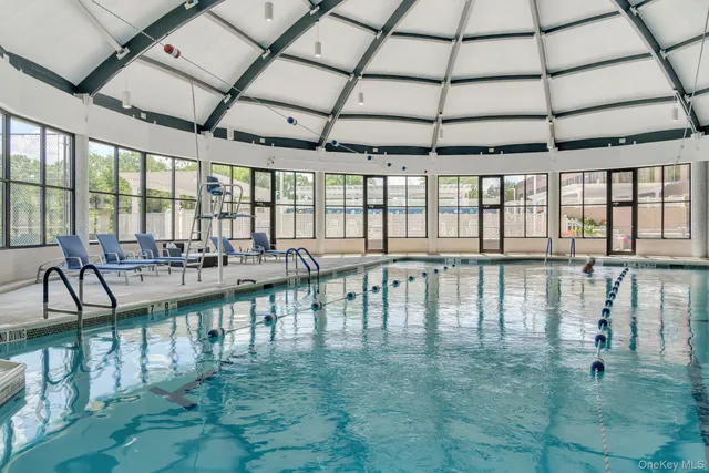 a view of a swimming pool with outdoor seating