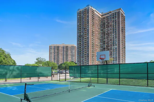 a view of a tall building next to a yard
