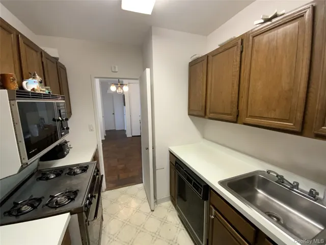a kitchen with a sink appliances and cabinets