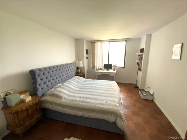 a bedroom with a bed and window