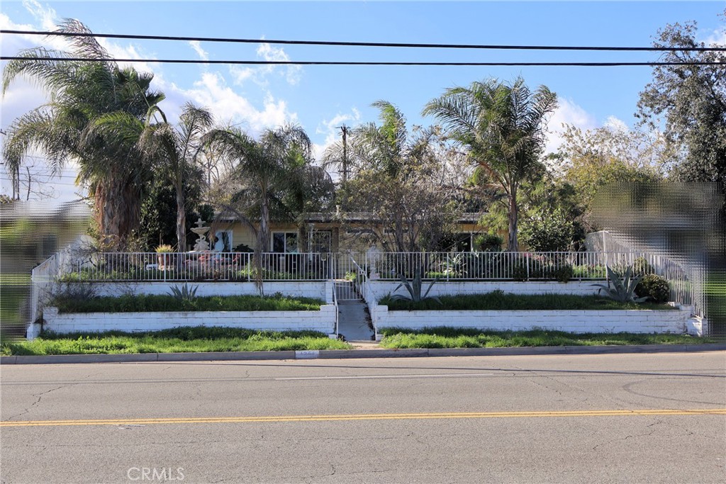 1261 North Rancho Avenue Colton, CA 92324 - Photo 1 of 27 a view of a yard with a street sign