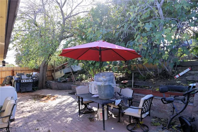 a view of backyard with outdoor seating and trees