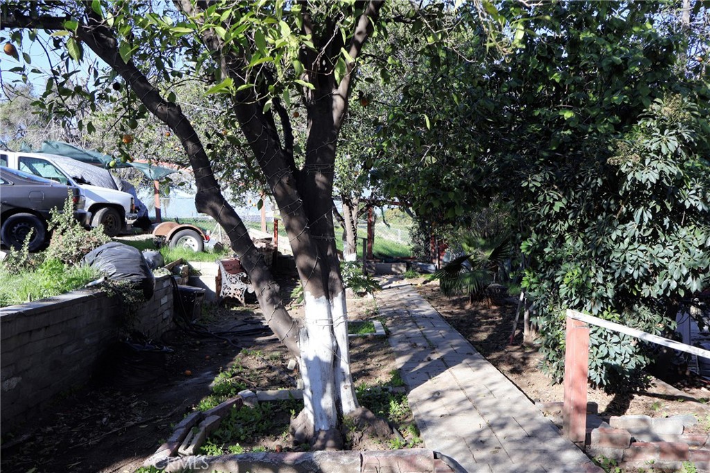 1261 North Rancho Avenue Colton, CA 92324 - Photo 9 of 27 a backyard of a house with lots of green space