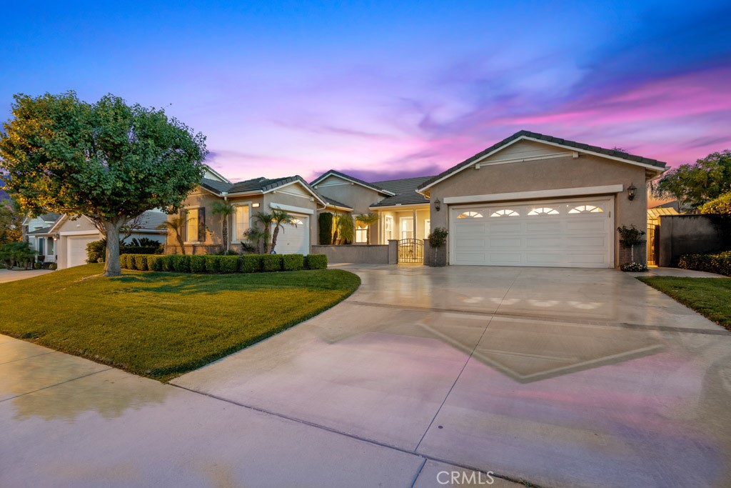 12663 Bougainvillea Way Riverside, CA 92503 - Photo 1 of 1 a front view of a house with a yard and garage