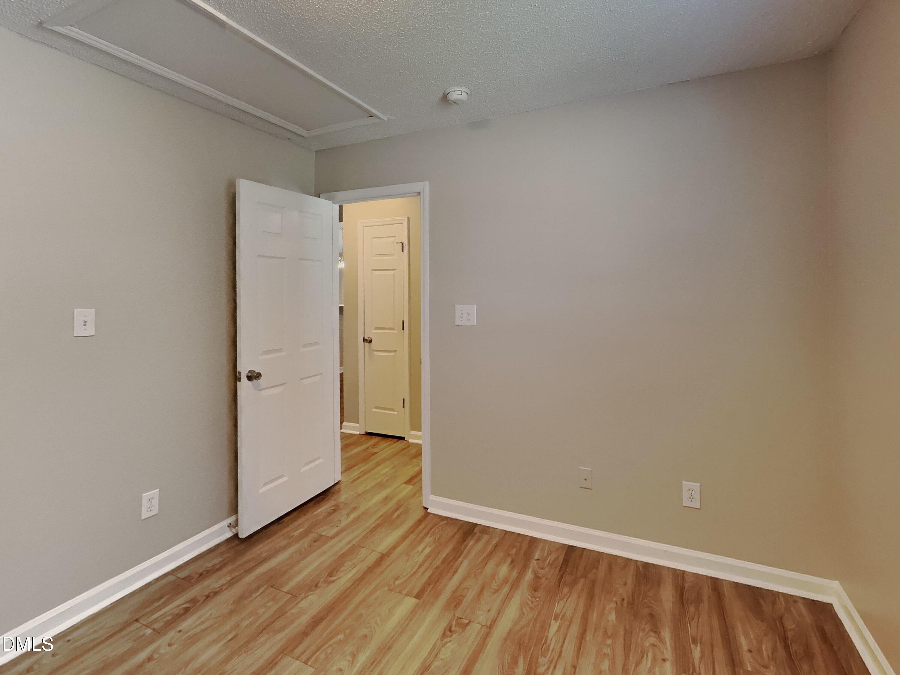 5516 Wilhagan Court Raleigh, NC 27616 - Photo 11 of 16 a view of an empty room with wooden floor and a window