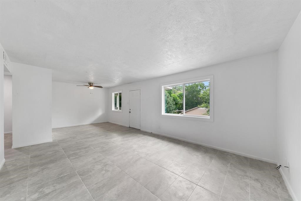 1312 West Adoue Street, Unit 7 Alvin, TX 77511 - Photo 3 of 7 an empty room with a window