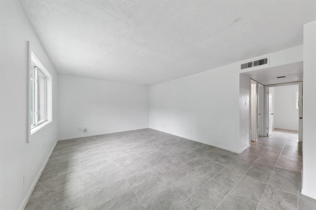 1312 West Adoue Street, Unit 7 Alvin, TX 77511 - Photo 4 of 7 a view of an empty room with a window