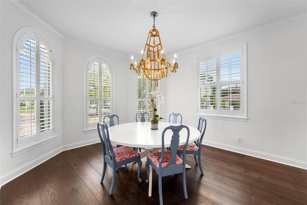 11 Formosa Avenue Tampa, FL 33606 - Photo 18 of 53 a dining room with furniture a chandelier and wooden floor