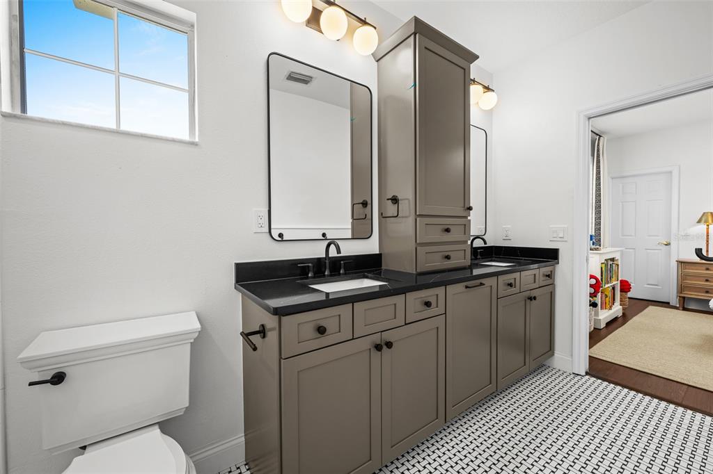 11 Formosa Avenue Tampa, FL 33606 - Photo 38 of 53 a bathroom with a granite countertop toilet sink and mirror