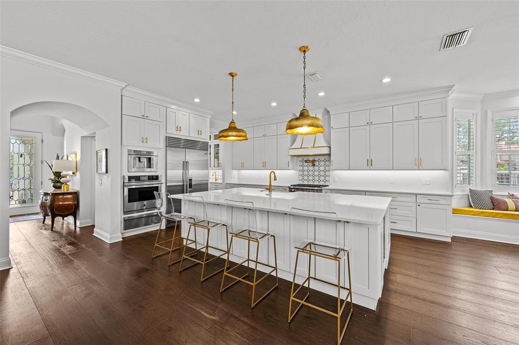 11 Formosa Avenue Tampa, FL 33606 - Photo 5 of 53 a kitchen with kitchen island granite countertop wooden floors and view of living room