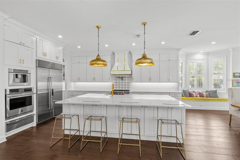 11 Formosa Avenue Tampa, FL 33606 - Photo 6 of 53 a kitchen with stainless steel appliances granite countertop a stove a kitchen island a dining table and chairs