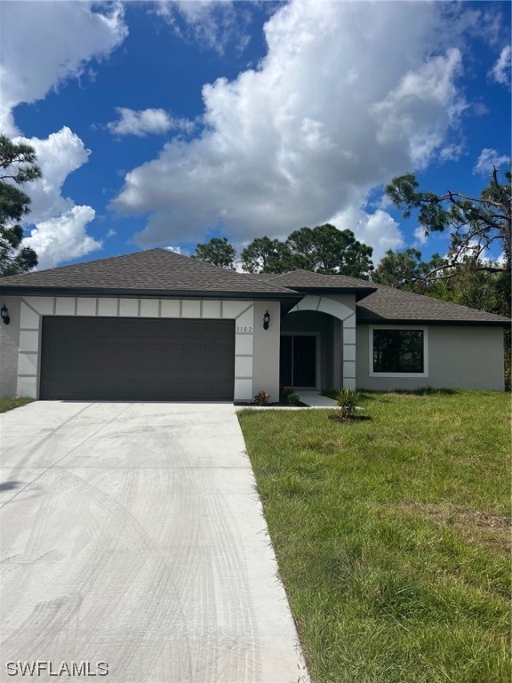 2615 27th Street West Lehigh Acres, FL 33971 - Photo 1 of 17 a front view of a house with a garden
