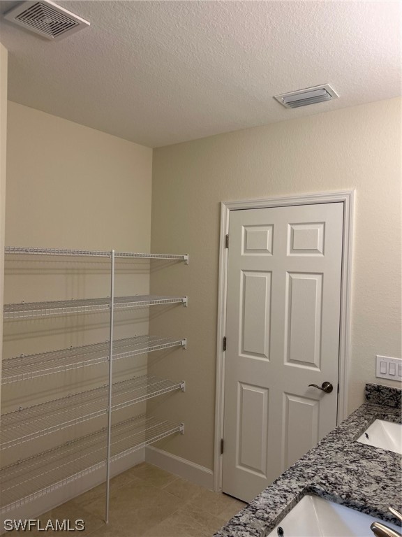 2615 27th Street West Lehigh Acres, FL 33971 - Photo 11 of 17 a bedroom with a bed and cabinets