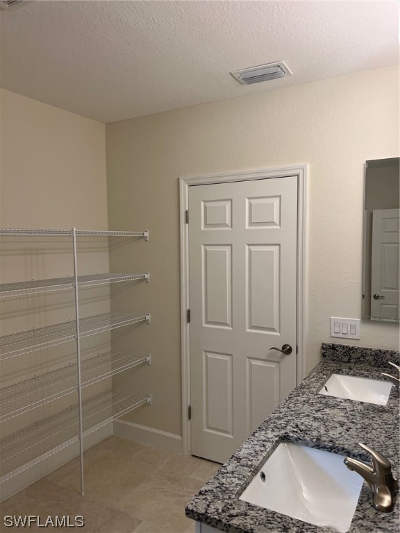 2615 27th Street West Lehigh Acres, FL 33971 - Photo 14 of 17 a bathroom with a sink and a mirror