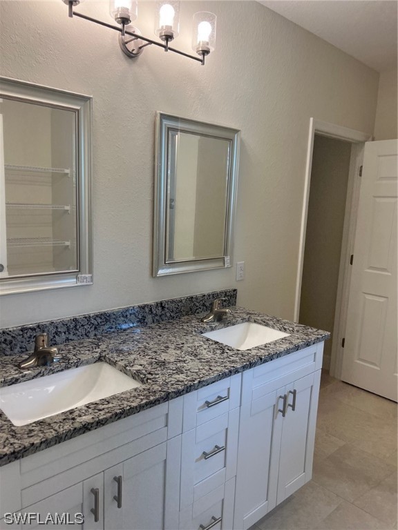 2615 27th Street West Lehigh Acres, FL 33971 - Photo 15 of 17 a bathroom with a granite countertop sink and a mirror