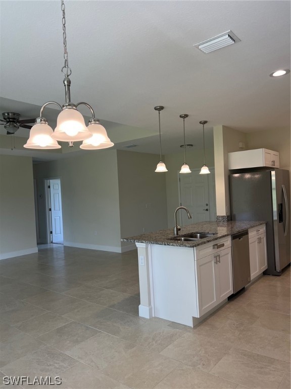 2615 27th Street West Lehigh Acres, FL 33971 - Photo 7 of 17 a kitchen with stainless steel appliances granite countertop a sink a stove and a wooden floors