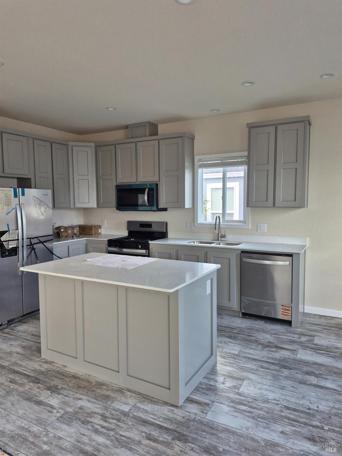 246 Apple Lane Santa Rosa, CA 95407 - Photo 2 of 12 a kitchen with kitchen island granite countertop a sink cabinets and stainless steel appliances