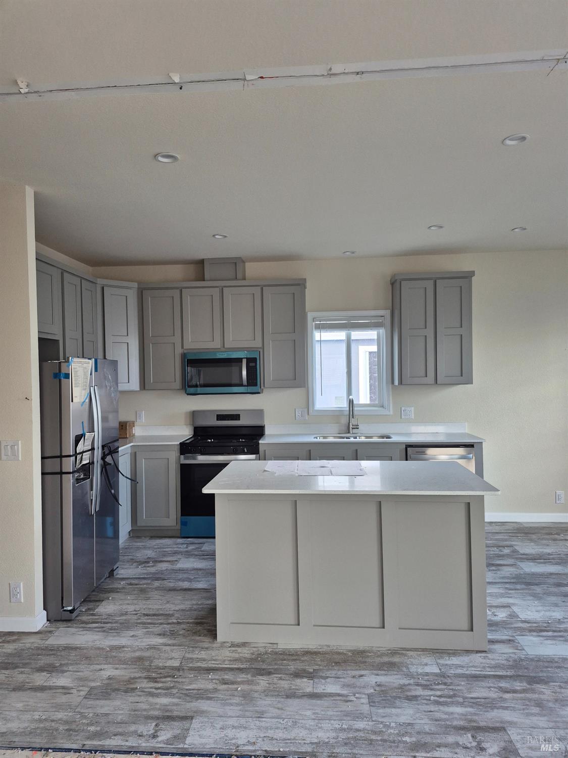 246 Apple Lane Santa Rosa, CA 95407 - Photo 7 of 12 a kitchen with kitchen island stainless steel appliances a sink stove and refrigerator