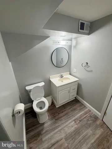 a bathroom with a toilet sink and mirror