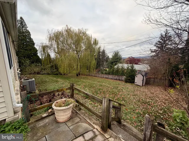 a view of a backyard with sitting area