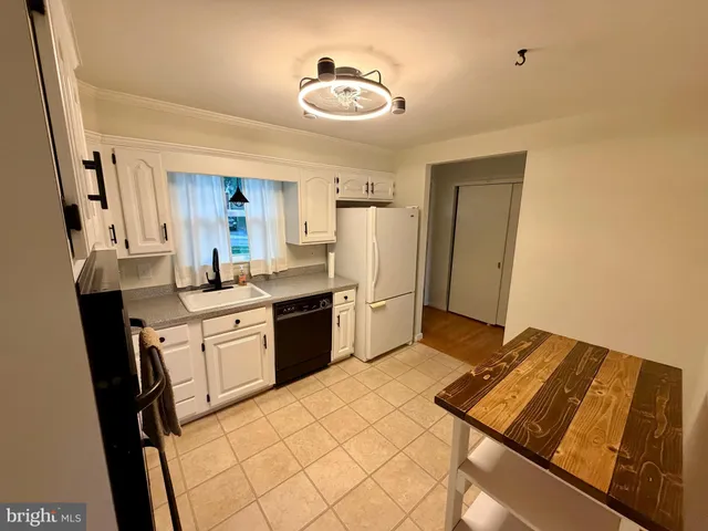 a kitchen with a sink appliances and cabinets
