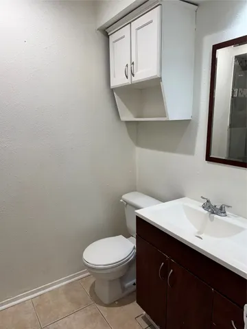 a bathroom with a sink a toilet and mirror