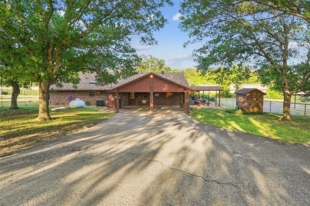 3030 Wager Road Flower Mound, TX 75028 - Photo 37 of 40 Brick exterior residence with an attached carport
