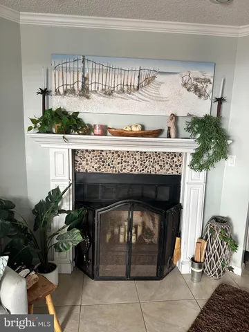 a fireplace with a potted plant on a table and chair