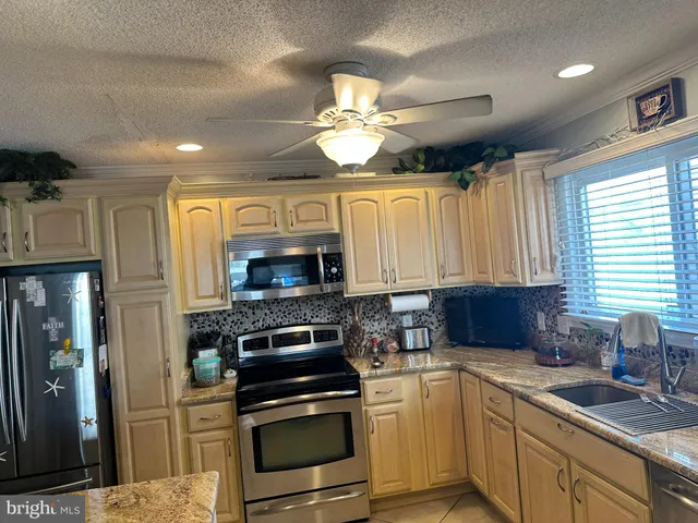 a kitchen with a stove window and cabinets
