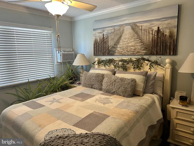 a large bed sitting in a bedroom next to a window