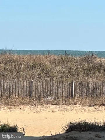 a view of a yard with wooden fence