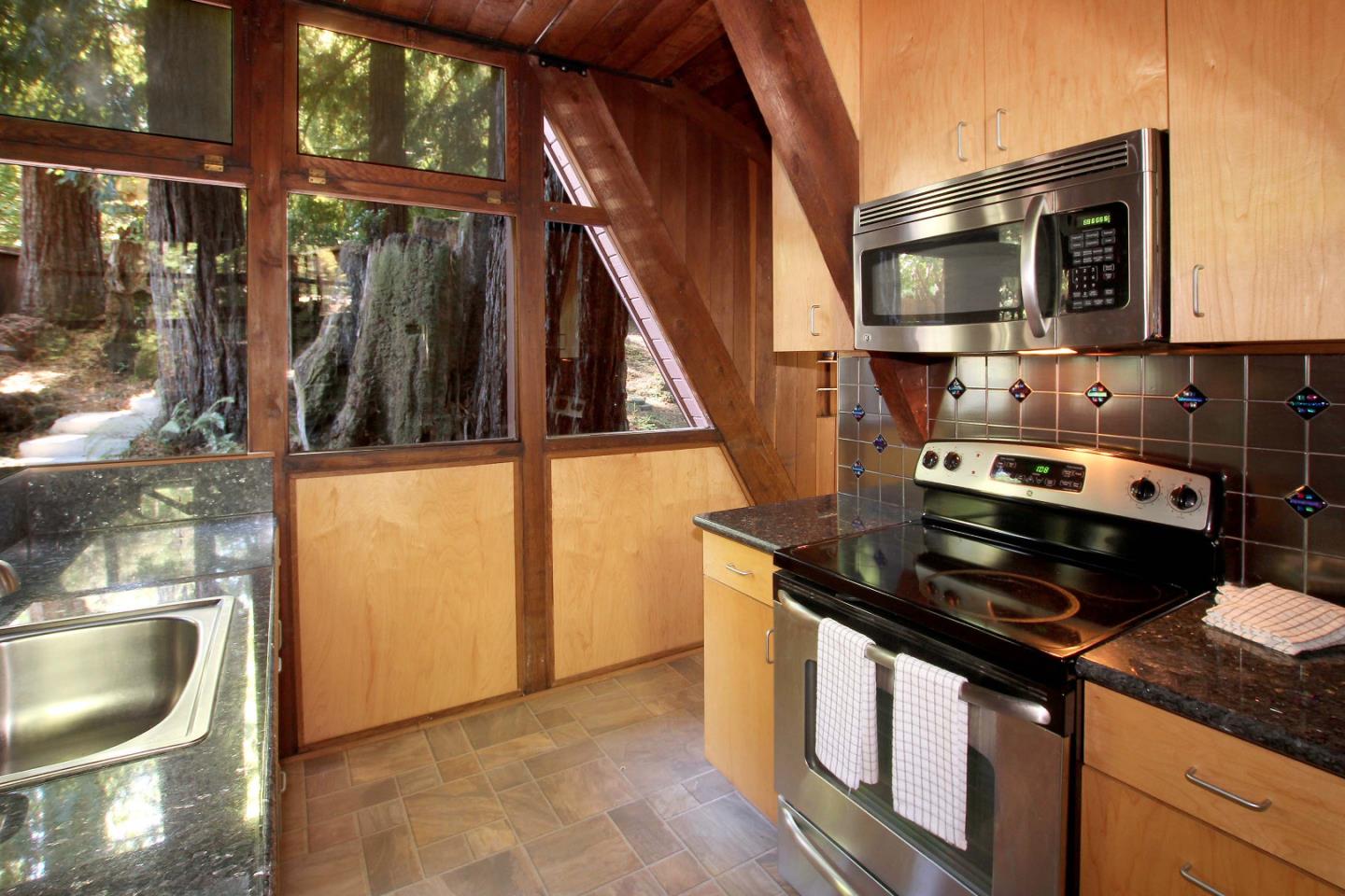 220 Shadowbrook Road Ben Lomond, CA 95005 - Photo 12 of 24 a kitchen with stainless steel appliances granite countertop a stove a microwave and a sink