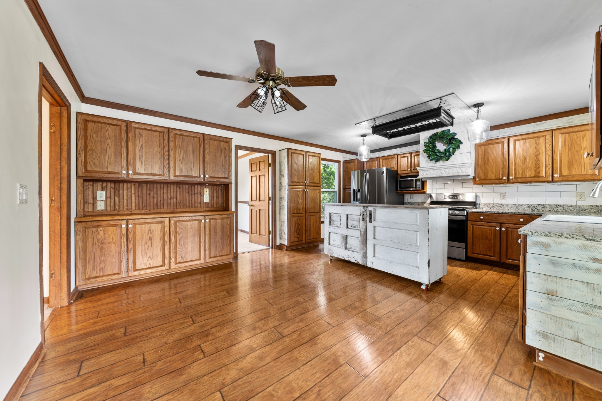 1056 South Cross Bridges Road Mount Pleasant, TN 38474 - Photo 14 of 30 a kitchen with stainless steel appliances granite countertop a refrigerator and a stove top oven
