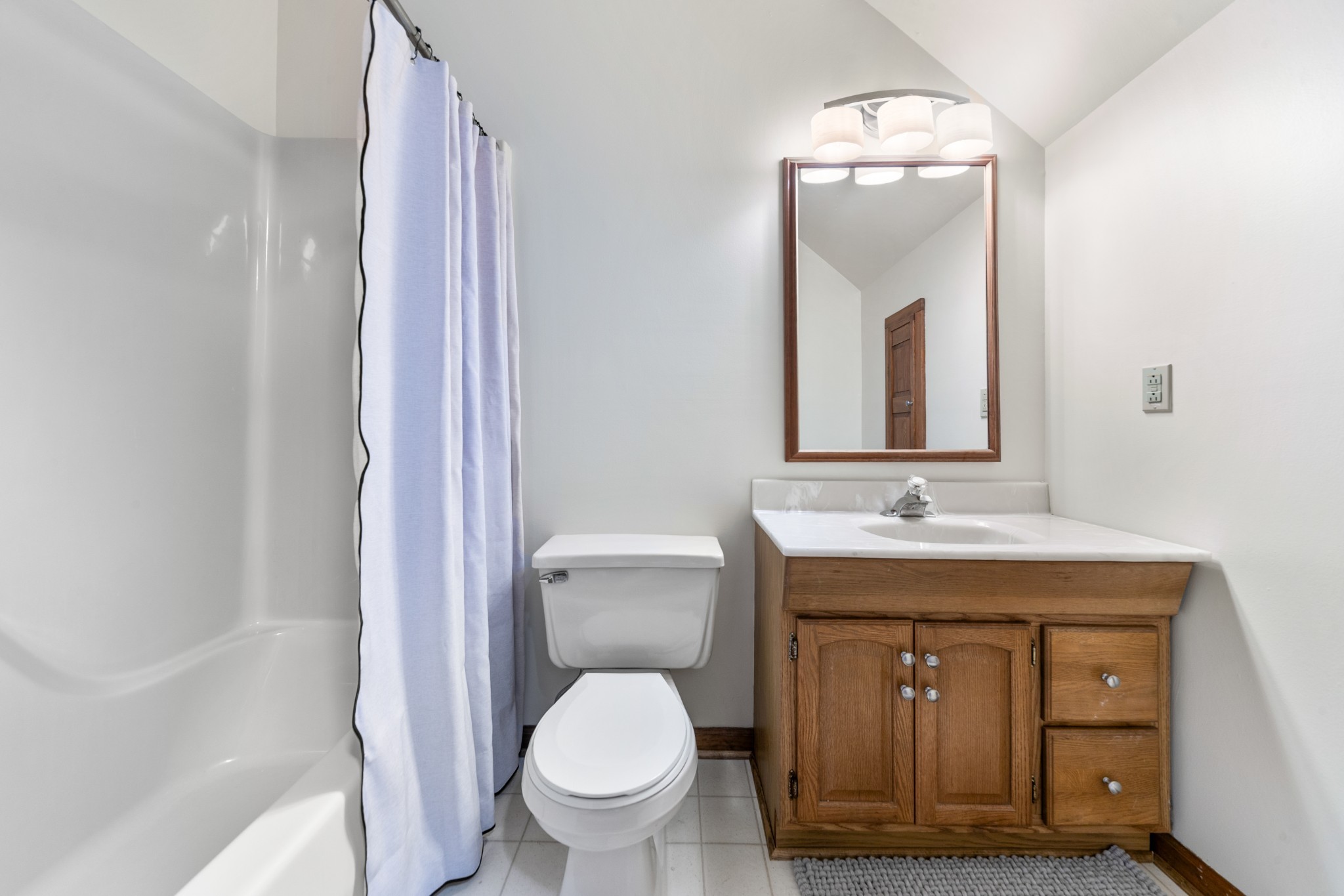 1056 South Cross Bridges Road Mount Pleasant, TN 38474 - Photo 22 of 30 a bathroom with a toilet a sink and mirror