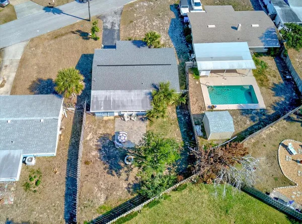 an aerial view of a house with a yard