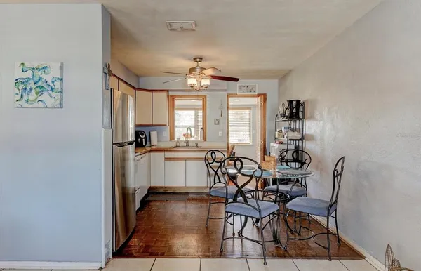 a view of a dining room with furniture and a chandelier