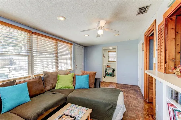 a bedroom with furniture and a large window