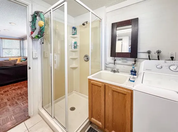 a bathroom with a sink a mirror and a shower
