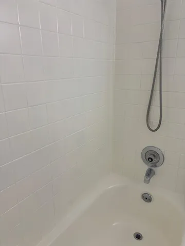 a white toilet sitting next to a bathroom sink