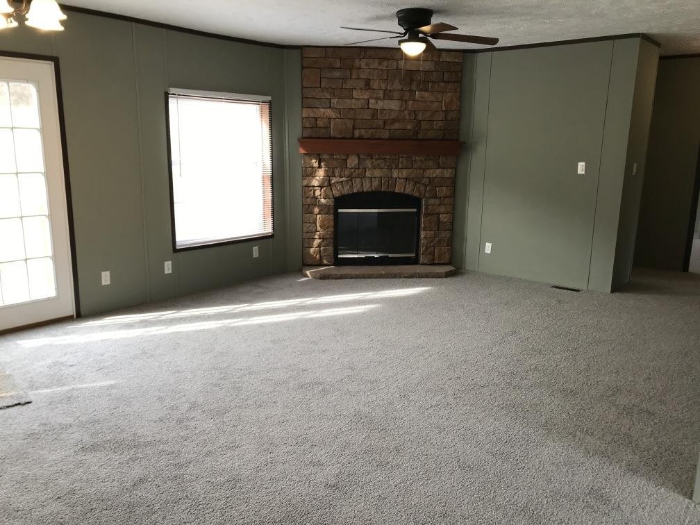157 Buckner Road Philadelphia, TN 37846 - Photo 3 of 30 an empty room with a fireplace and window