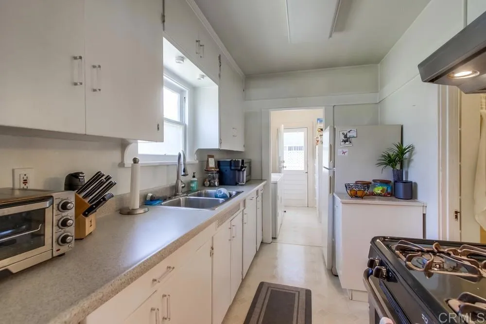 4217 Third Avenue San Diego, CA 92103 - Photo 11 of 16 a kitchen with sink a stove and cabinets