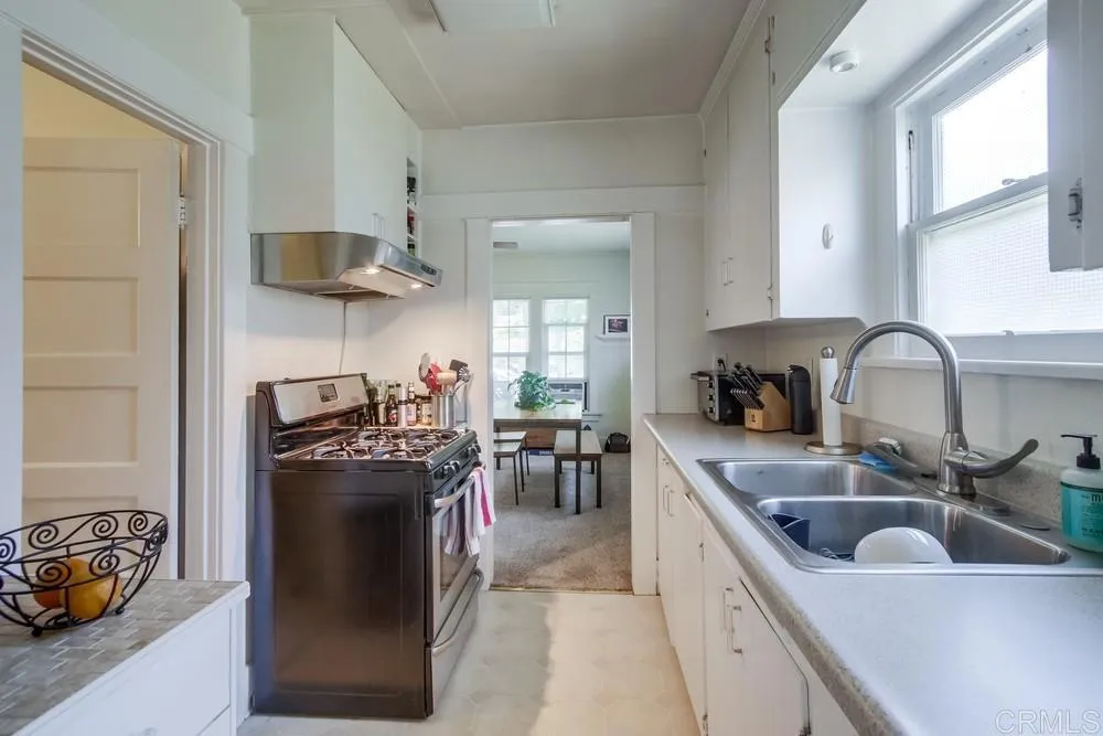 4217 Third Avenue San Diego, CA 92103 - Photo 12 of 16 a kitchen with stainless steel appliances granite countertop a sink stove and refrigerator